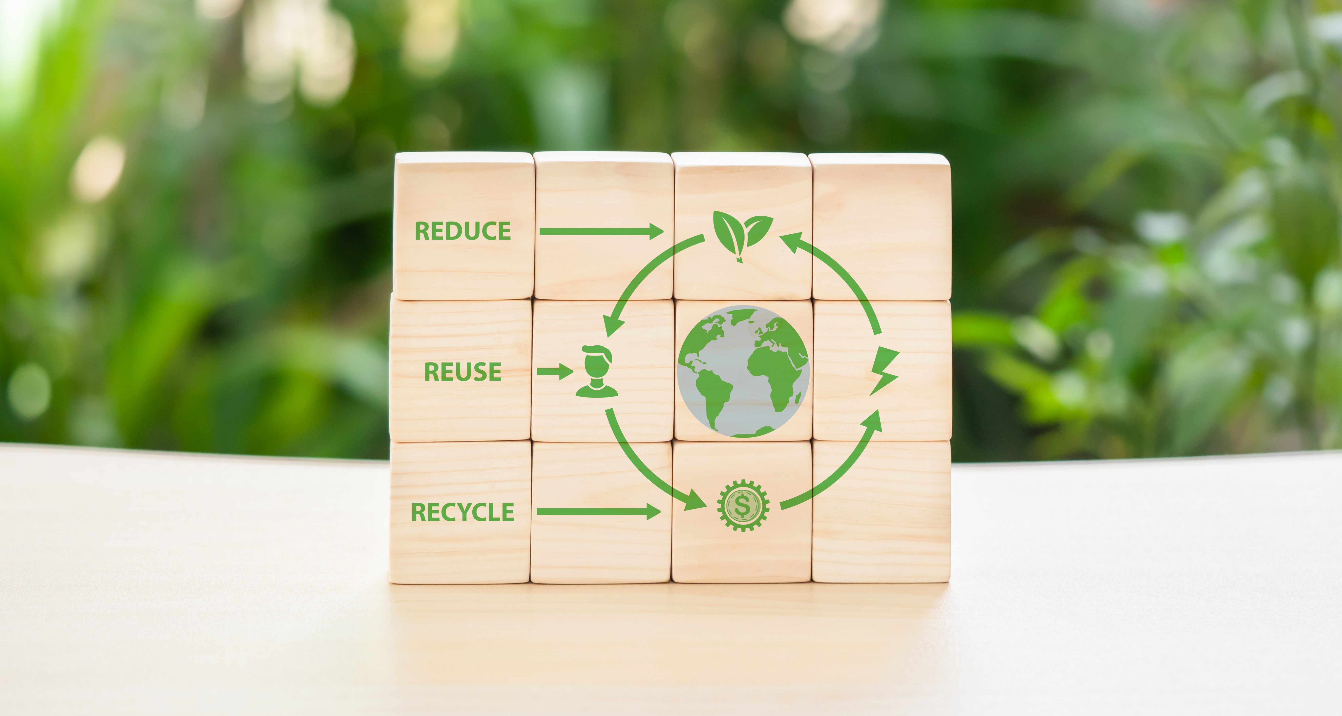 Drewniane klocki z zielonymi symbolami ekologii.